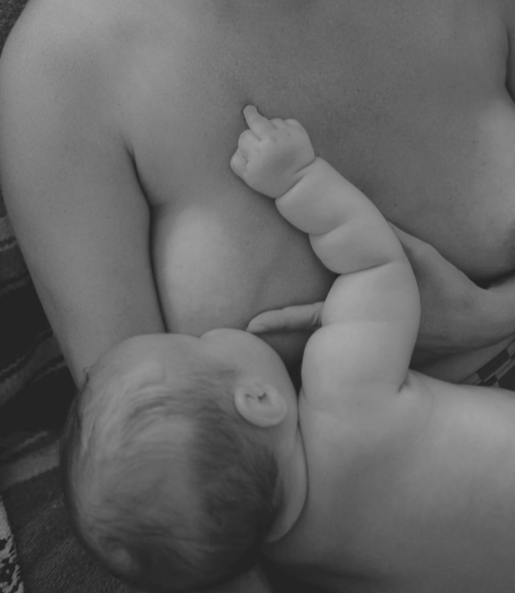 Mother breastfeeding her newborn baby
